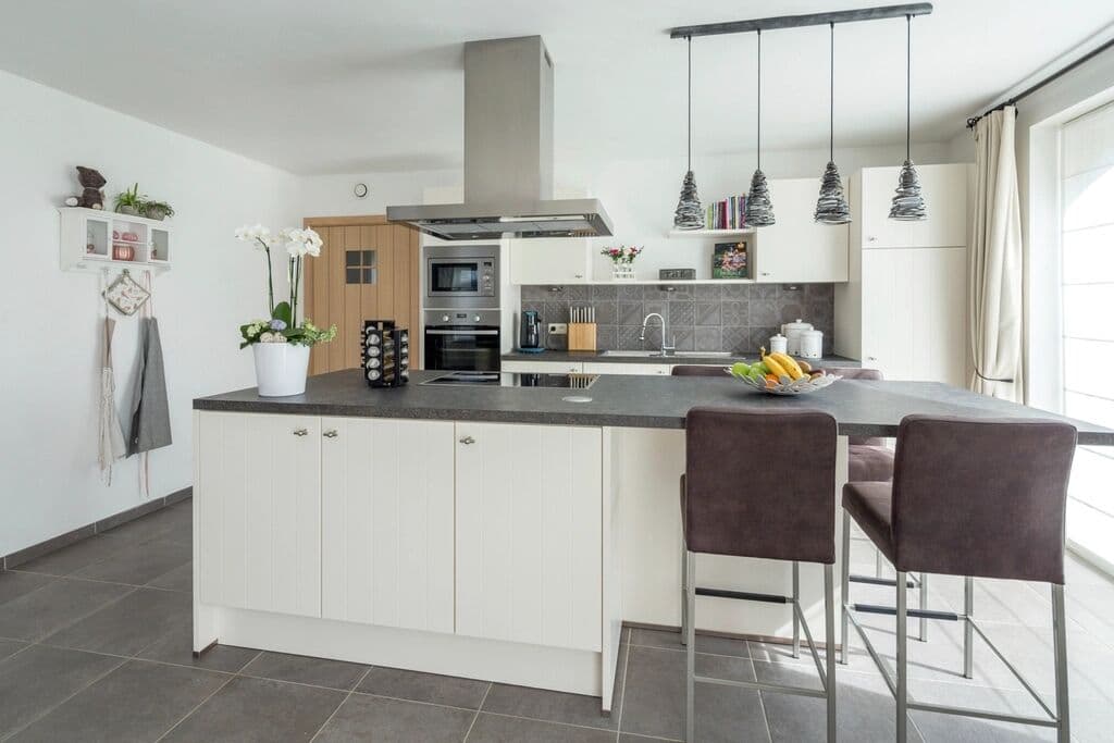 Shared kitchen with an island and bar stools